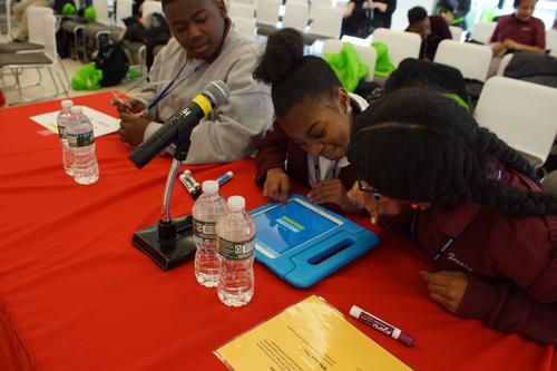 Teams of sixth graders from three Philadelphia schools used iPads to buzz in and answer literature questions. 